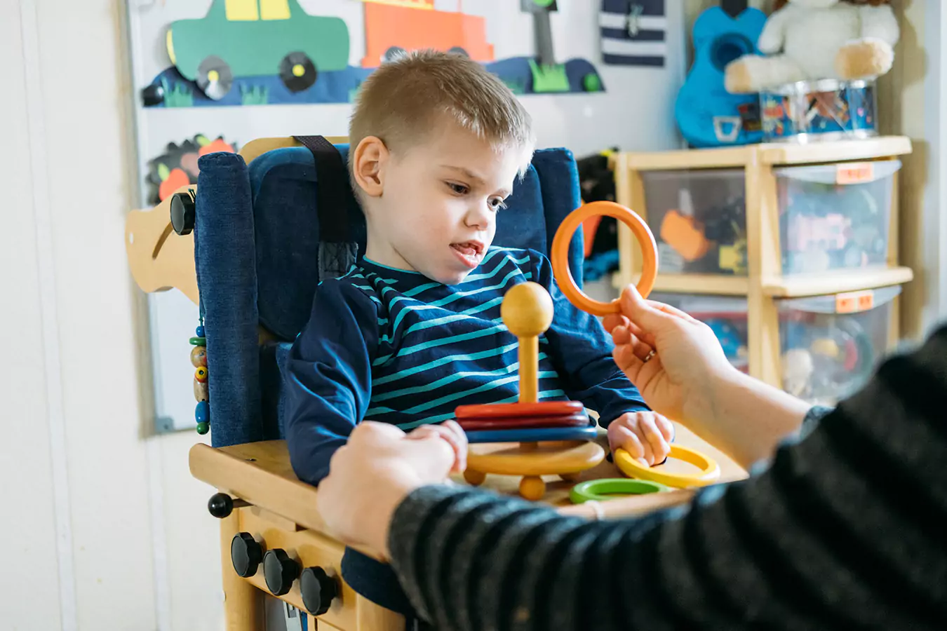 A disabled boy looking at circle shapes